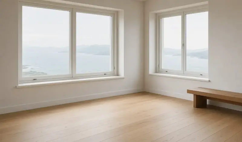 Illustrative: interior room with new white-framed casement windows overlooking the water and a finished sill — illustrative only, not a real Board of Project Stewardship job photo
